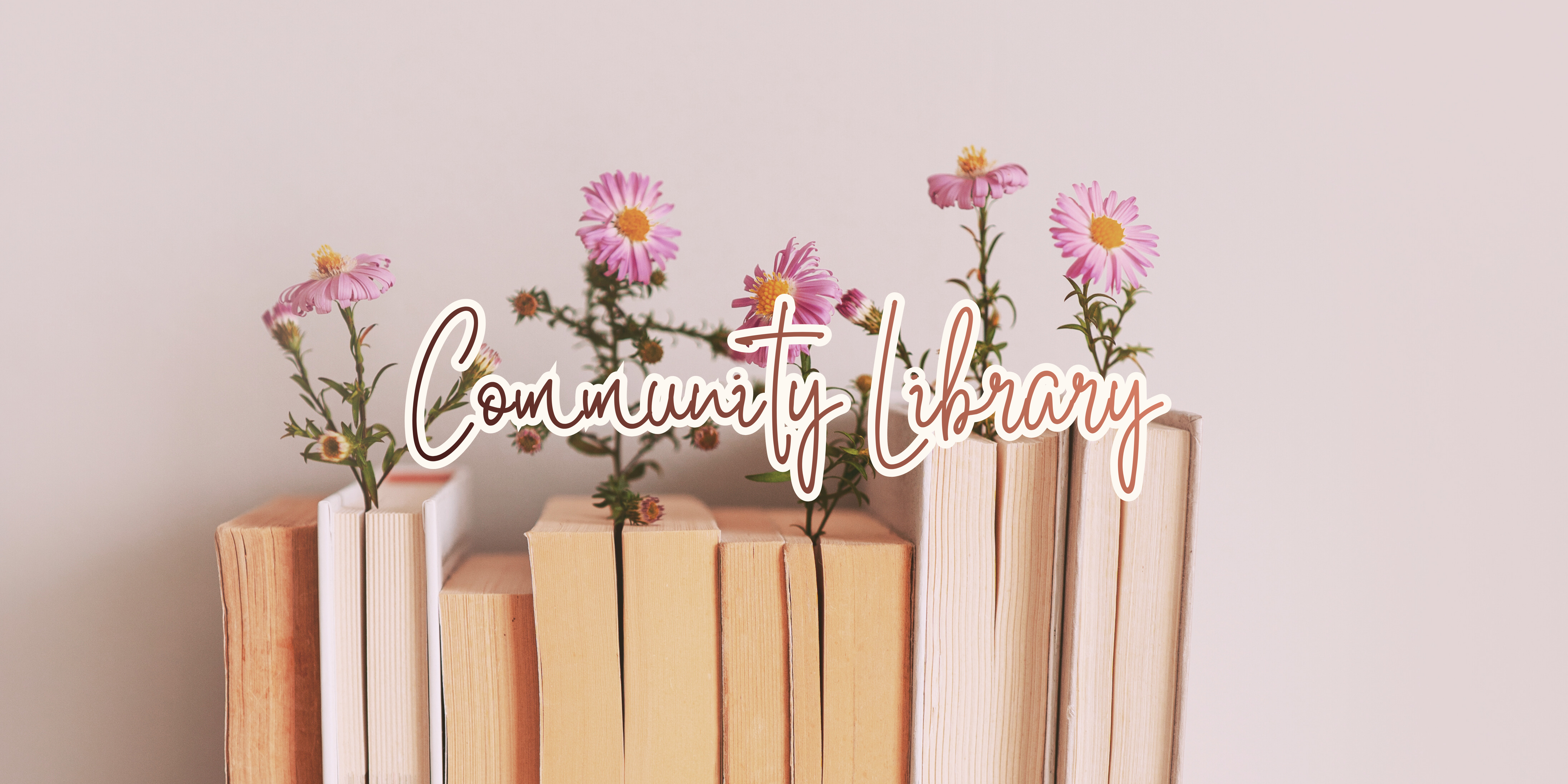Stack of books with flowers on top, labeled 'Community Library' on a light background