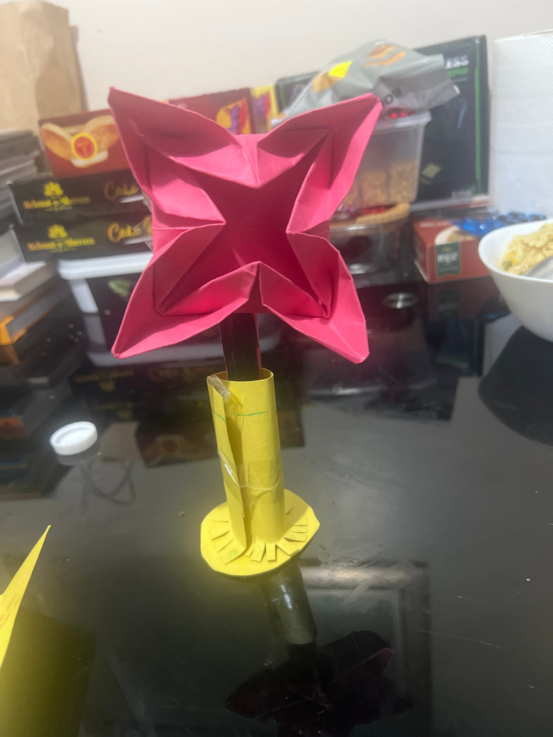 Pink butterfly-shaped object on a bottle with a blurred background