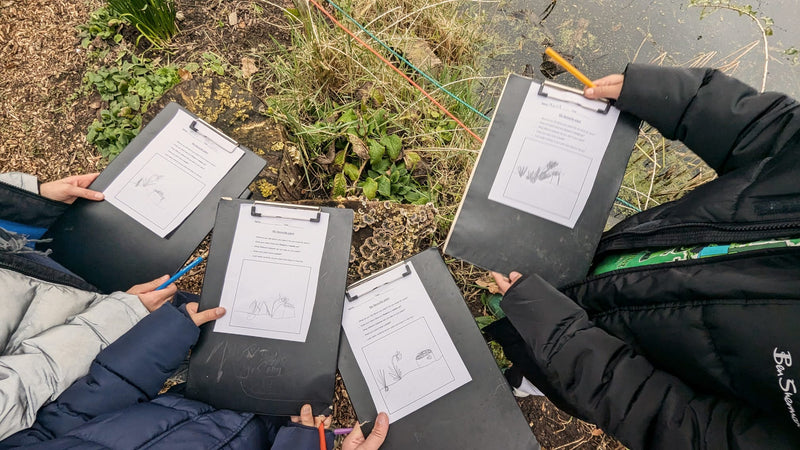People holding clipboards with papers in an outdoor setting